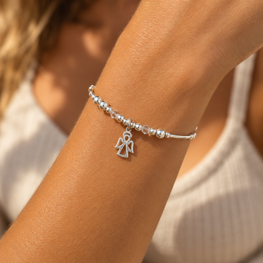 Model wearing an Angel charm women's sterling silver stacking bracelet by My Silver Wish