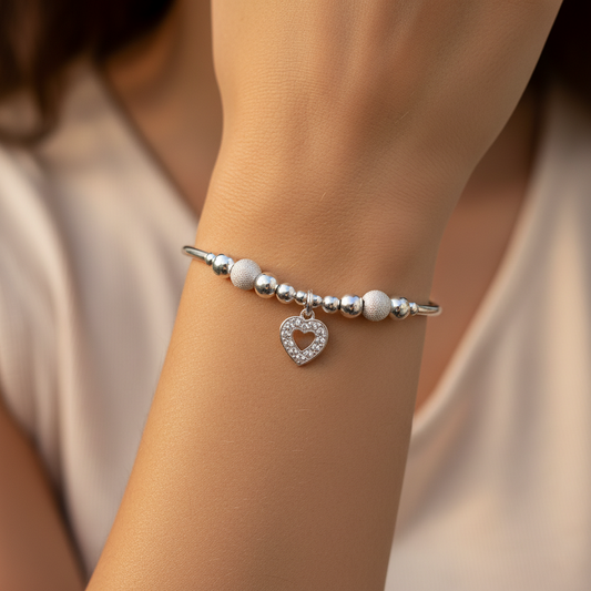 Model wearing a Diamond heart charm starburst beads sterling silver hand-made women's stacking bracelet by My Silver Wish