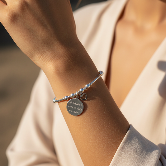 Model wearing a "Mother's Love is Like No Other" & heart charm women's sterling silver stacking bracelet by My Silver Wish