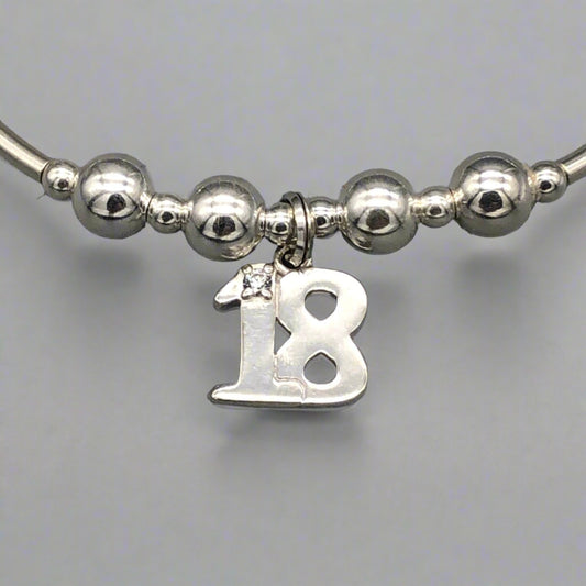 Close up of 18th Birthday charm girl's sterling silver stacking bracelet by My Silver Wish