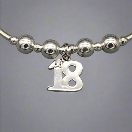 Close up of 18th Birthday charm girl's sterling silver stacking bracelet by My Silver Wish