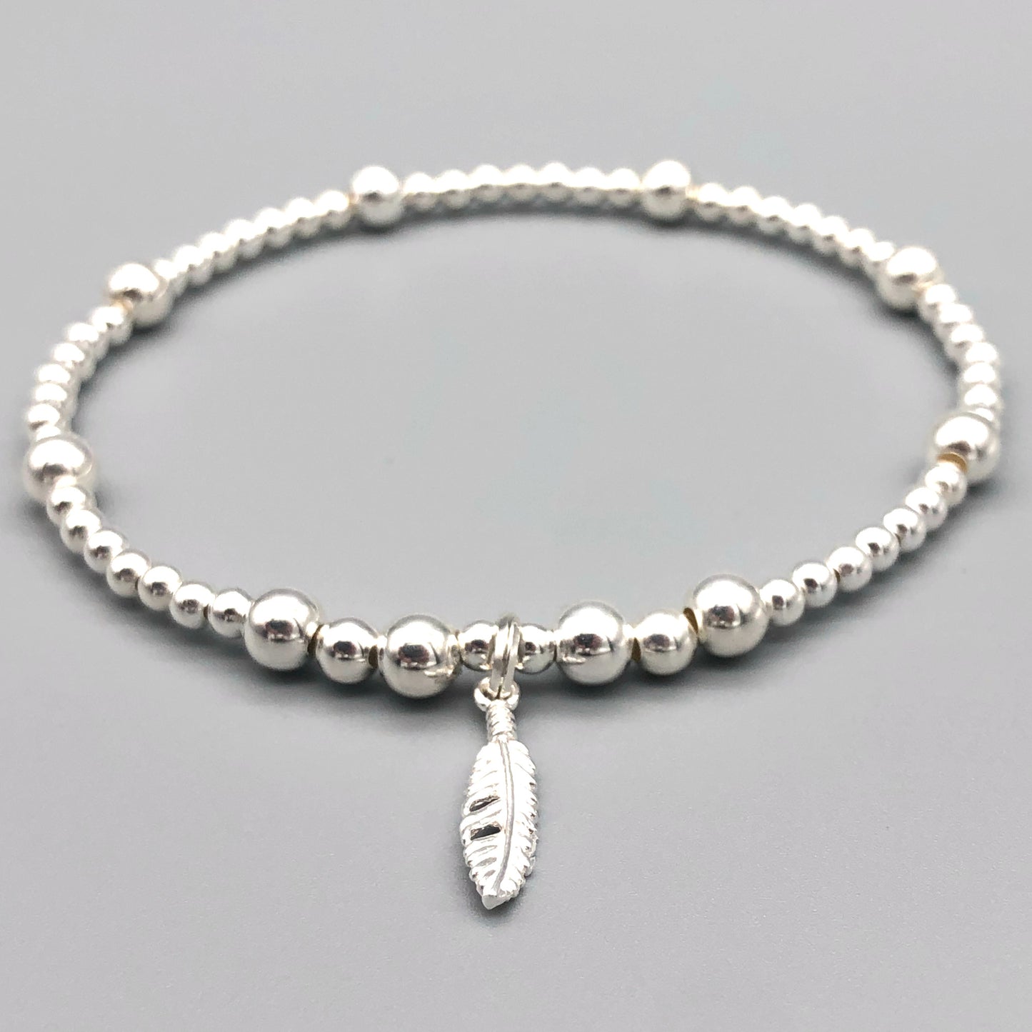Feather charm sterling silver stacking charm bracelet by My Silver Wish