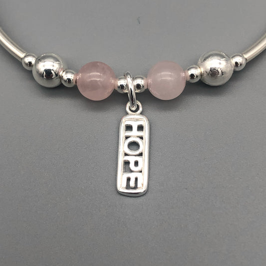Closeup of "Hope" rose quartz healing crystal women's silver stacking charm bracelet by My Silver Wish