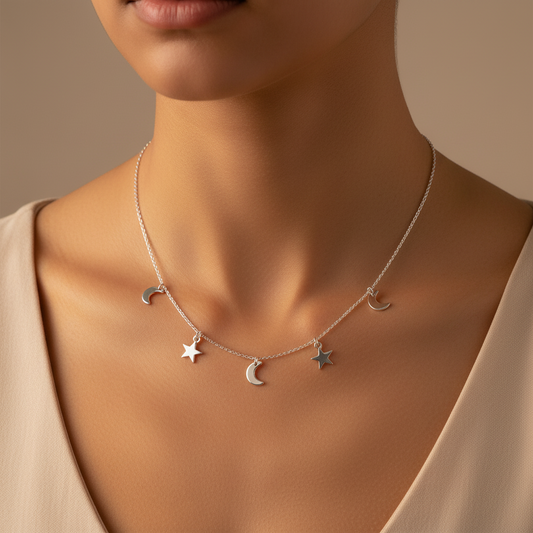Model wearing a Silver necklace with moon and star charms on a white background