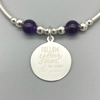 Closeup of "Follow your dreams, they know the way" amethyst & sterling silver women's stacking bracelet by My Silver Wish