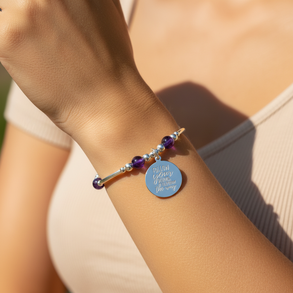 Model wearing a "Follow your dreams, they know the way" amethyst & sterling silver women's stacking bracelet by My Silver Wish