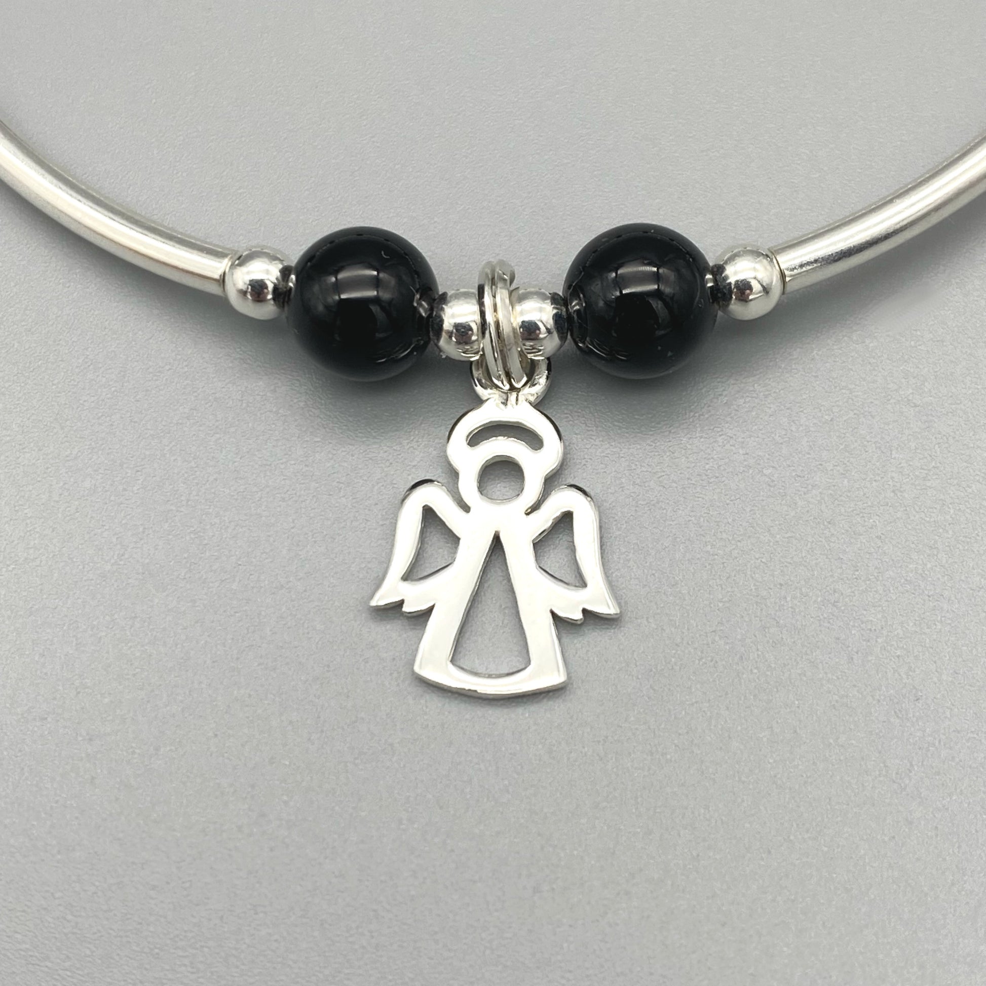 Closeup of Angel charm black onyx gemstone women's sterling silver stacking bracelet by My Silver Wish