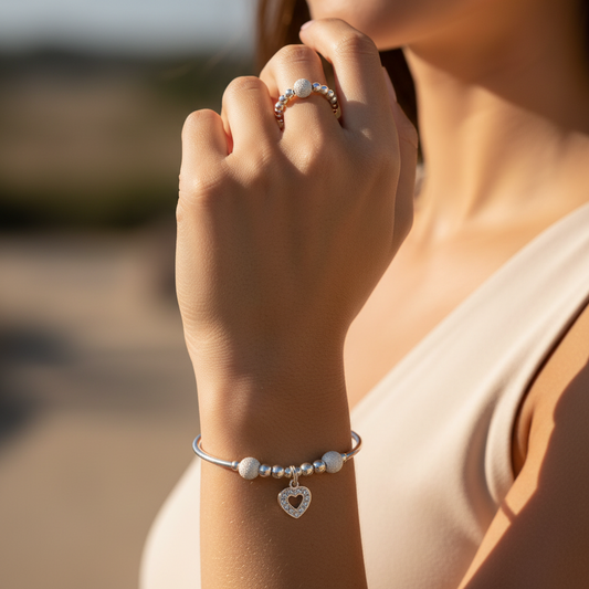 Model wearing aDiamond heart charm sterling silver women's stacking bracelet & stack ring set by My Silver Wish