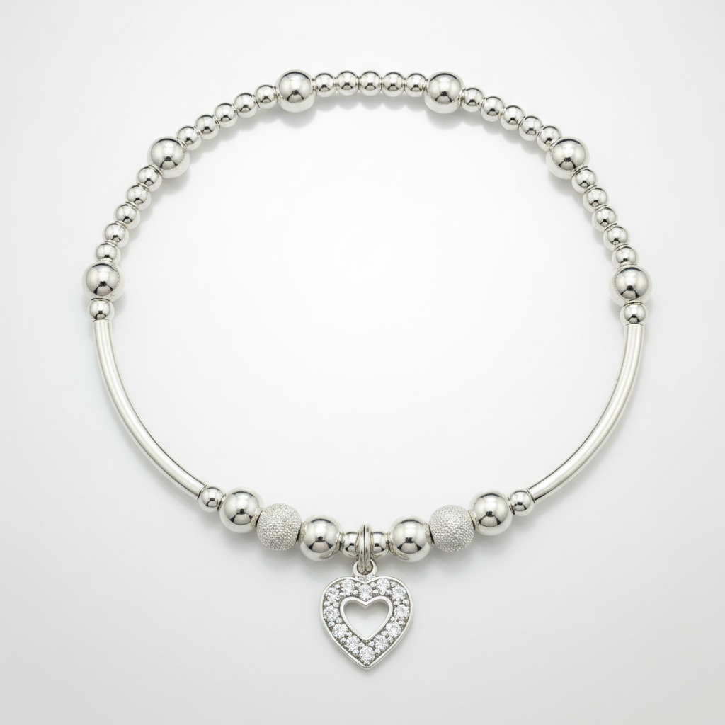 Silver bracelet with heart charm on a white background