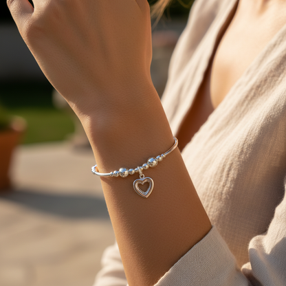 Model wearing a Crystal heart charm sterling silver hand-made stacking bracelet for her by My Silver Wish