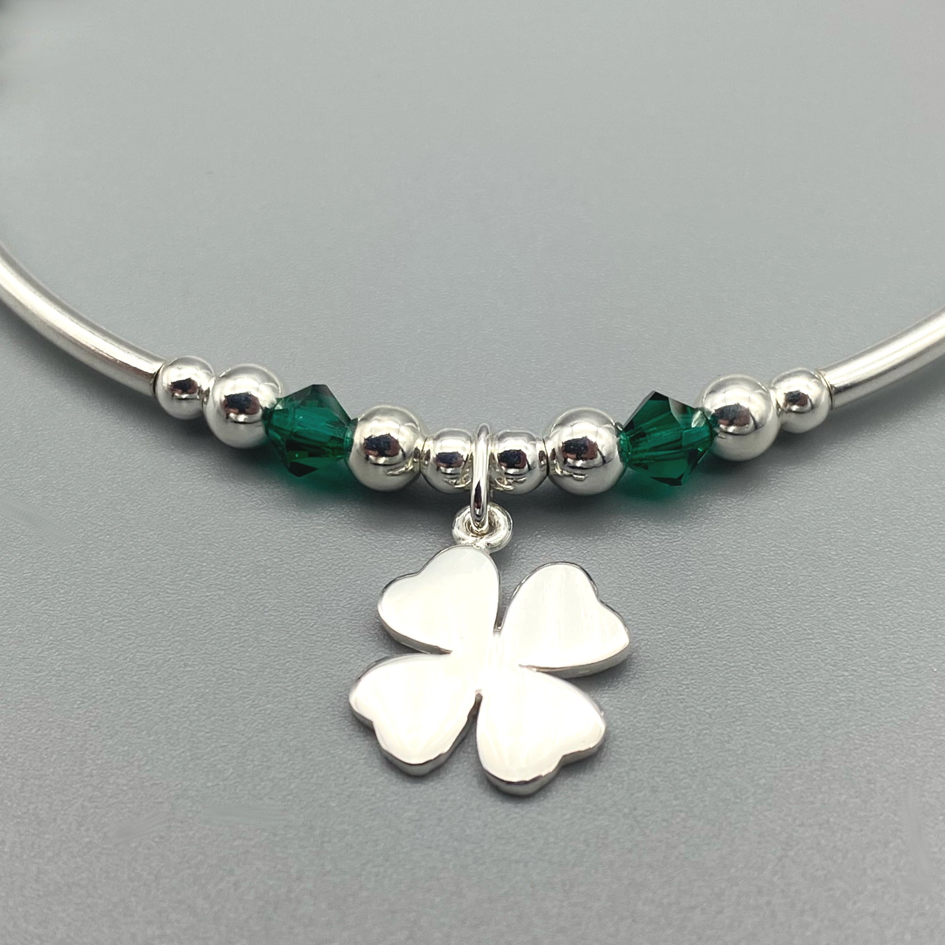 Closeup of "Good Luck" charm four leaf clover sterling silver hand-made stacking bracelet by My Silver Wish