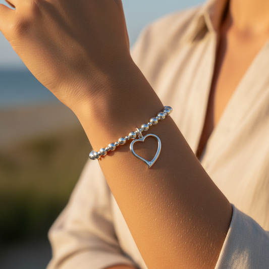 Model wearing a Open heart charm women's sterling silver stacking bracelet by My Silver Wish