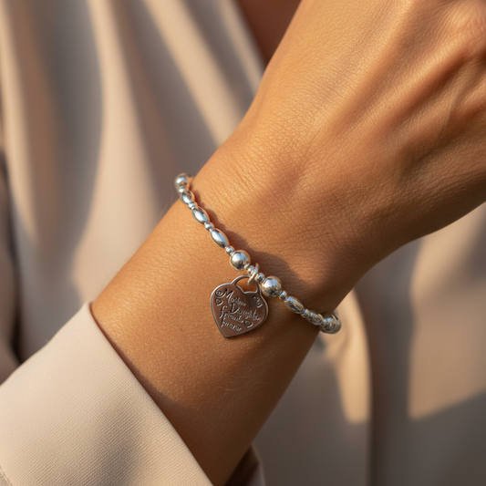 Woman wearing  a "Mother & daughter, friends forever" charm sterling silver women's stacking bracelet by My Silver Wish