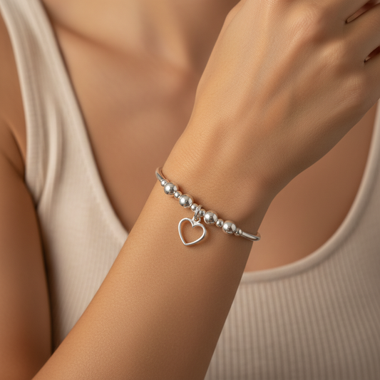 Woman wearing Delicate open heart charm sterling silver hand-made women's stacking bracelet by My Silver Wish