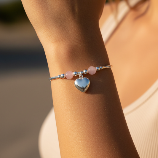 Model wearing a Rose quartz solid heart charm sterling silver hand-made stacking bracelet for her by My Silver Wish