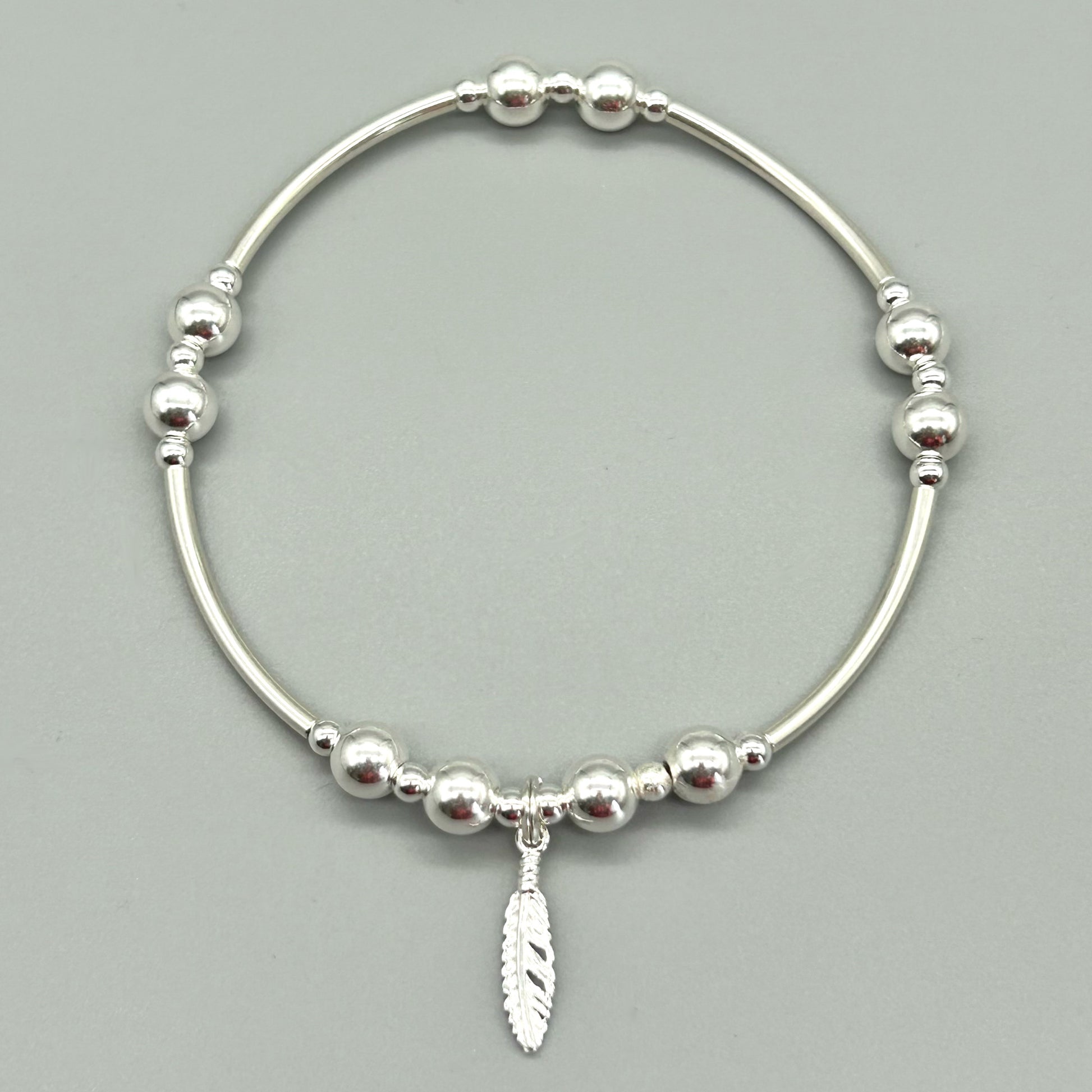 Feather charm silver stacking bracelet by My Silver Wish