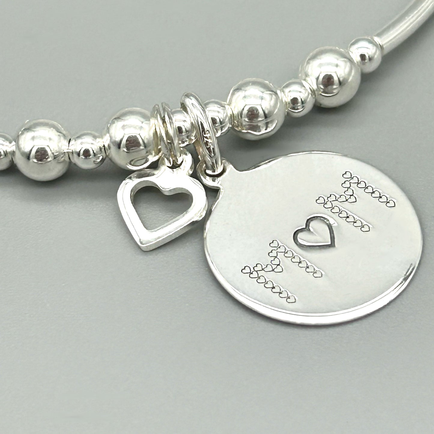 Closeup of "Mother's Love is Like No Other" & heart charm women's sterling silver stacking bracelet by My Silver Wish