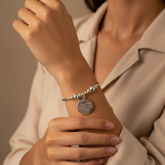Woman wearing "A true friend reaches for your hand, but touches your heart" women's sterling silver stacking bracelet by My Silver Wish