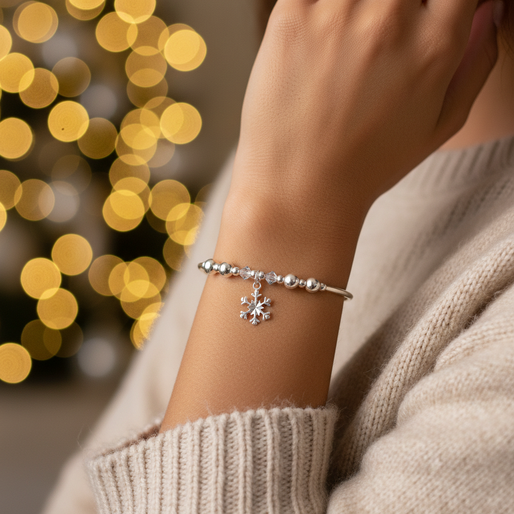 Model wearing a Snowflake charm sterling silver hand-made women's stacking bracelet by My Silver Wish