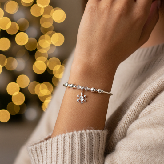 Model wearing a Snowflake charm sterling silver hand-made women's stacking bracelet by My Silver Wish