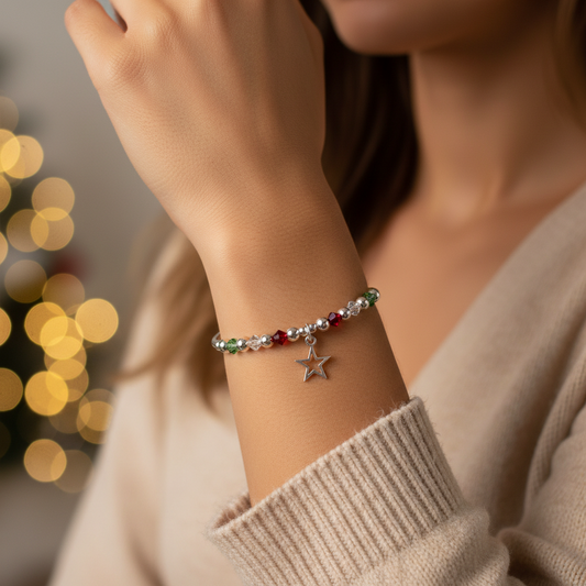Model wearing a Christmas open star charm with red, clear and green Swarovski crystal beads sterling silver women's stacking bracelet by My Silver Wish