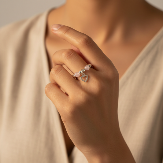 Model wearing a Open heart charm rose quartz & sterling silver bead stacking ring for her by My Silver Wish