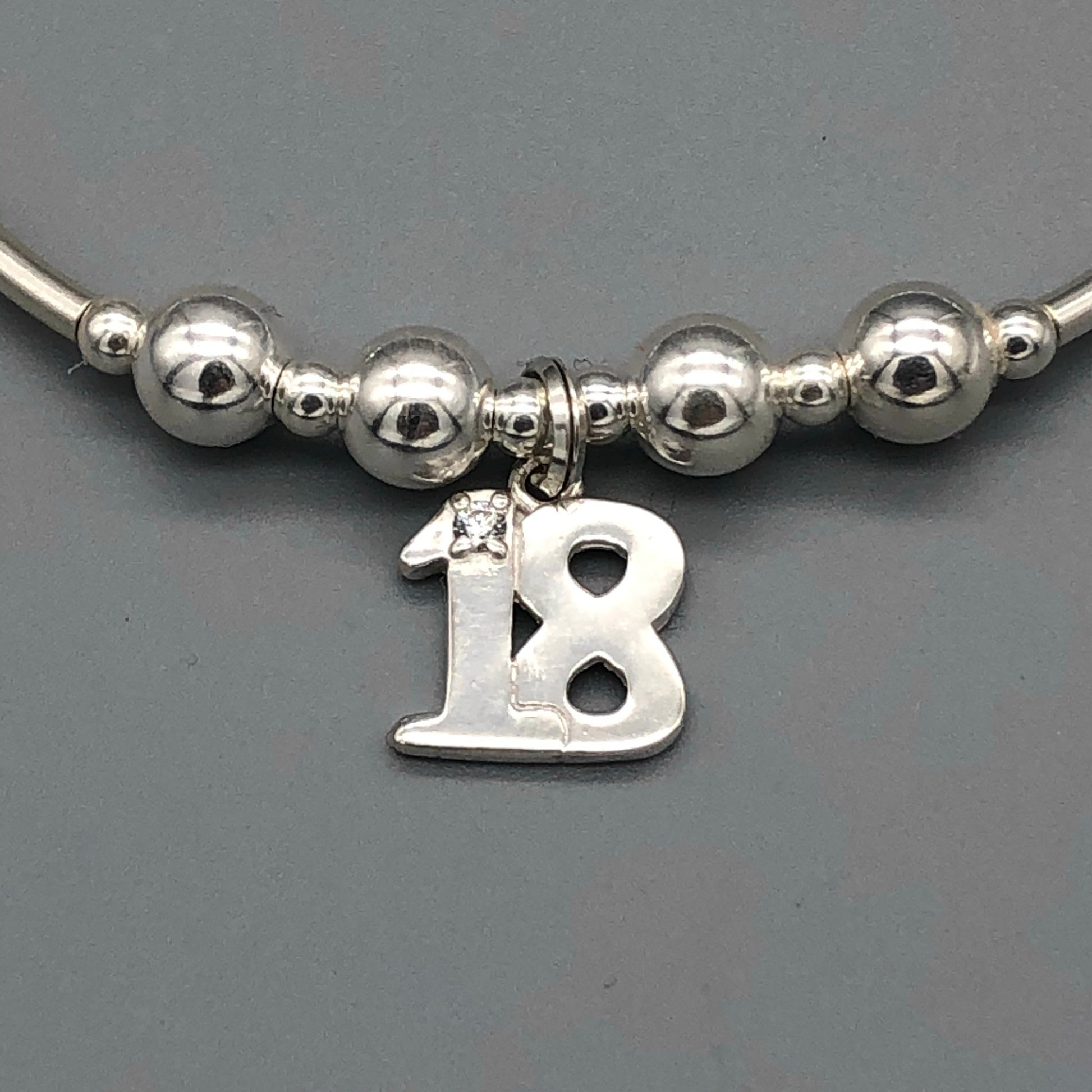 Close up of 18th Birthday charm girl's sterling silver stacking bracelet by My Silver Wish