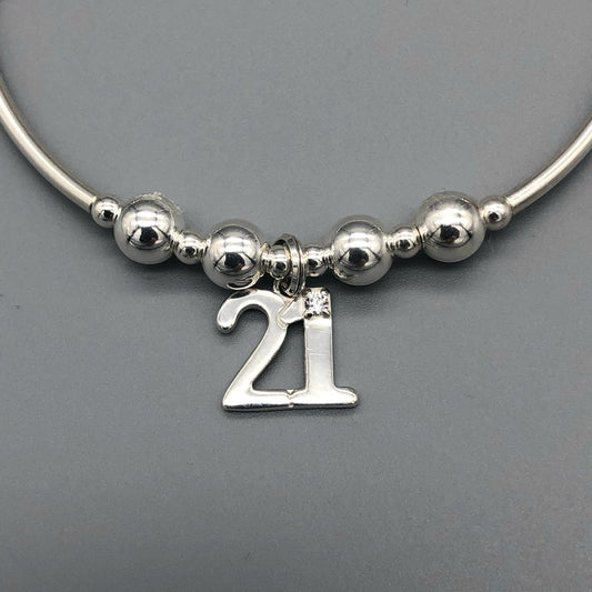 Closeup of 21st Birthday charm women's sterling silver stacking bracelet by My Silver Wish