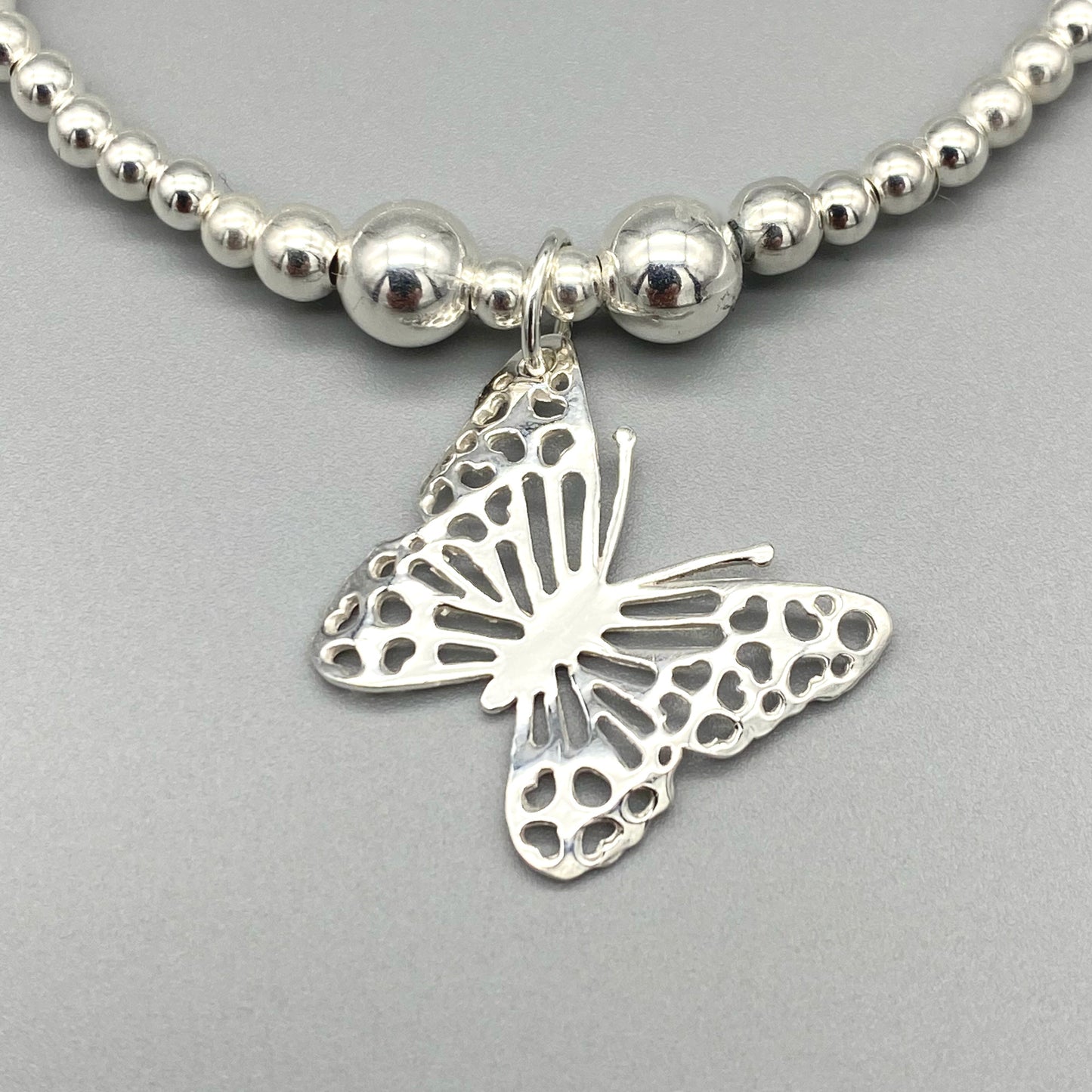 Closeup of Butterfly charm sterling silver stacking bracelet for her by My Silver Wish
