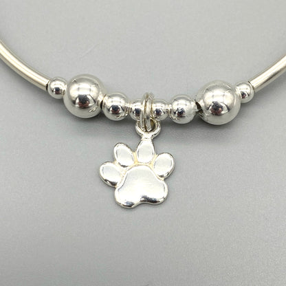 Closeup of Dog paw charm women's sterling silver stacking bracelet by My Silver Wish