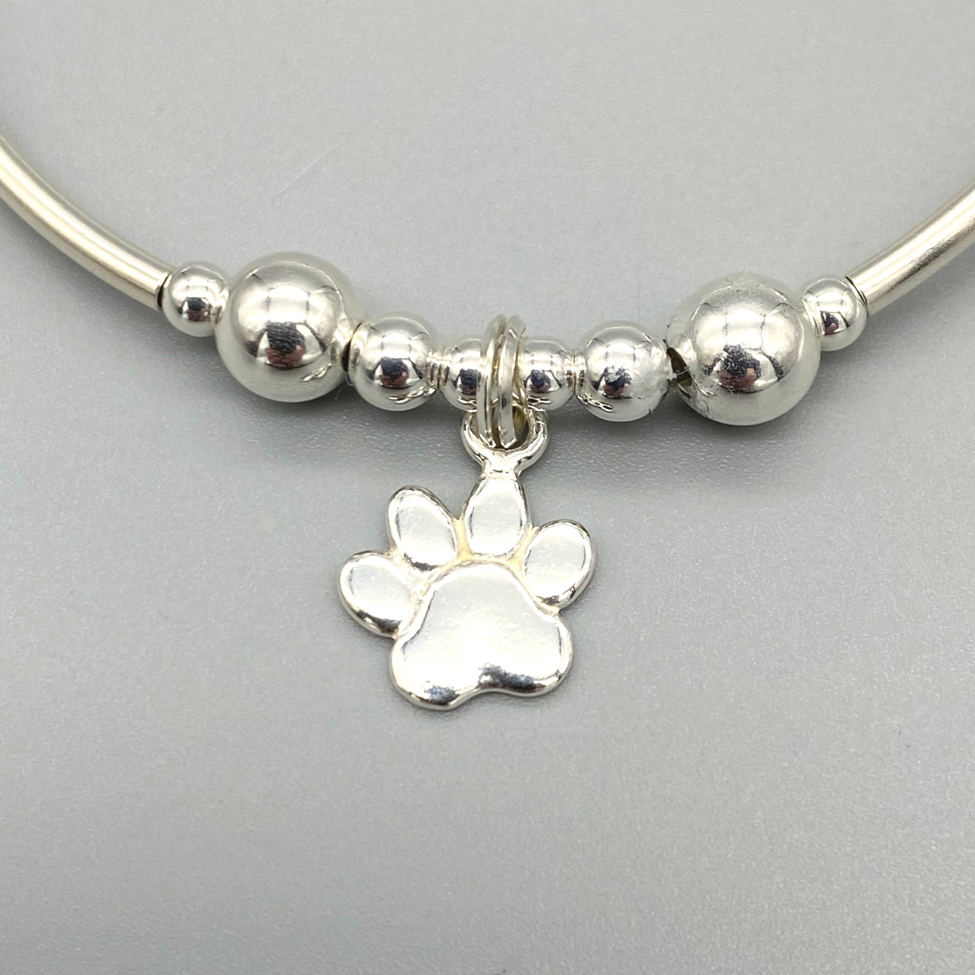 Closeup of Cat paw charm women's sterling silver stacking bracelet by My Silver Wish