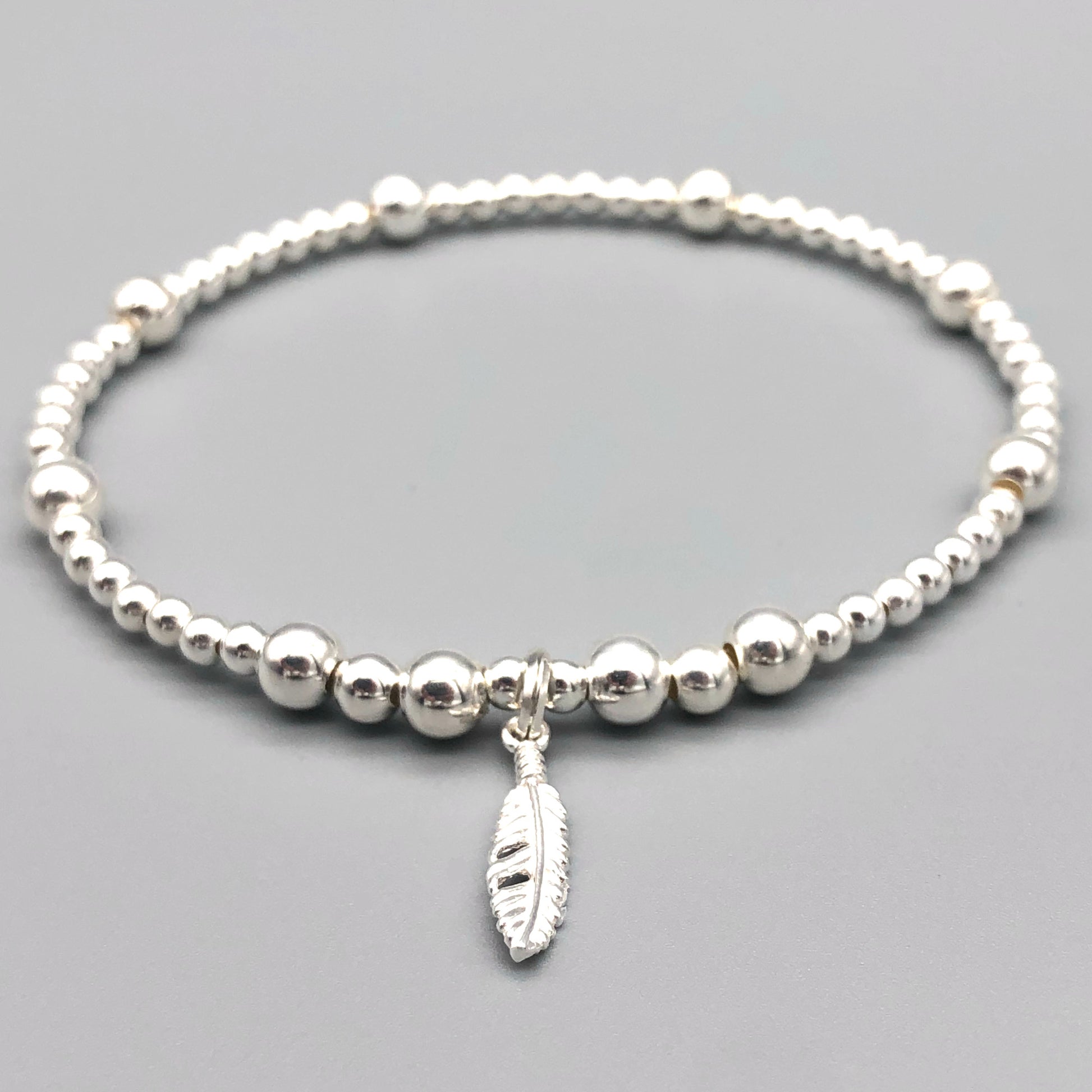 Feather charm sterling silver stacking charm bracelet by My Silver Wish