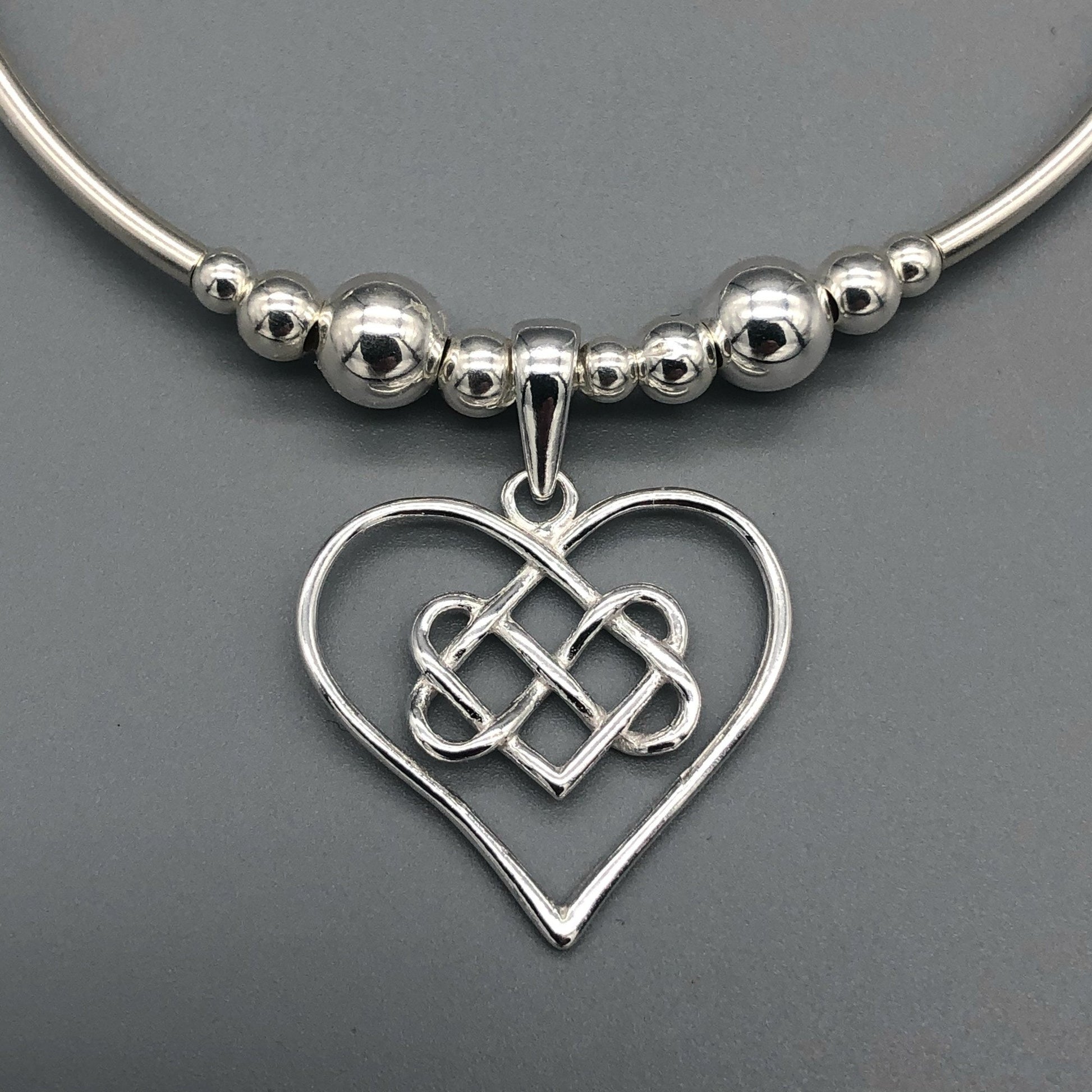 Closeup of Infinity charm heart women's sterling silver hand-made stacking bracelet by My Silver Wish