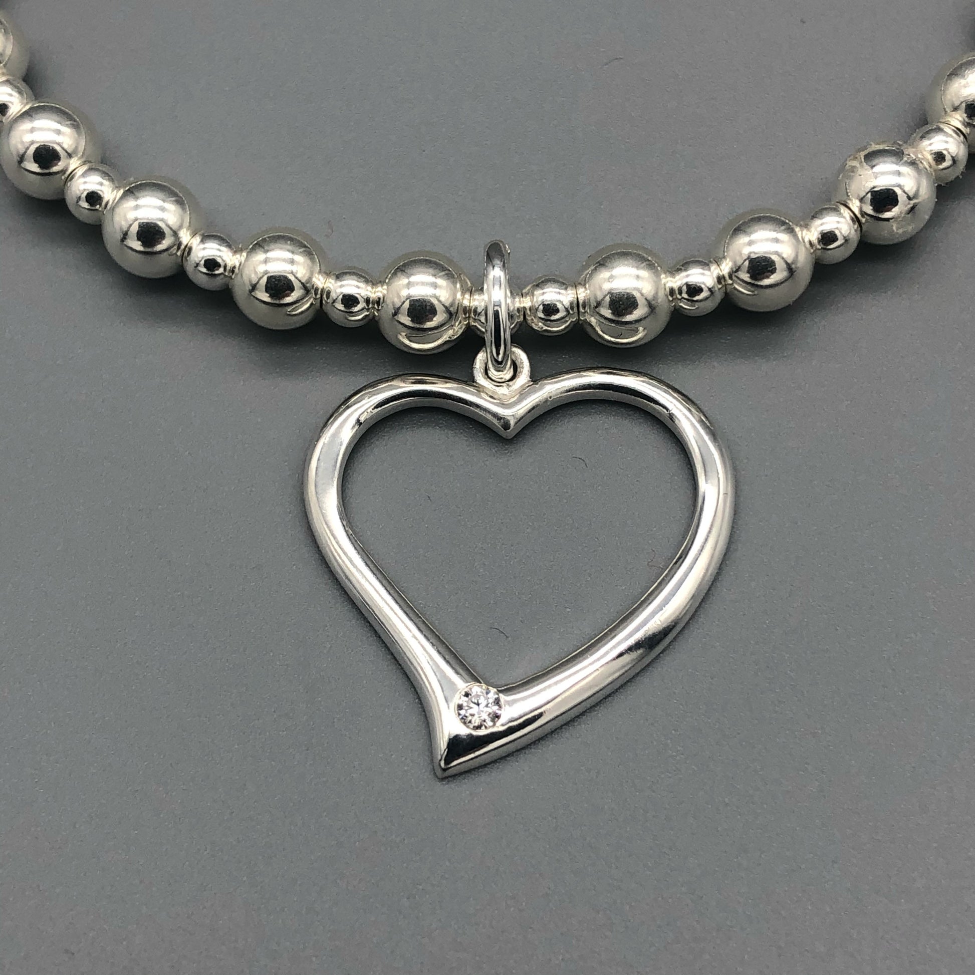 Closeup of Large open heart sterling silver stacking charm bracelet by My Silver Wish