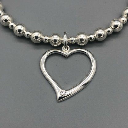 Closeup of Large open heart sterling silver stacking charm bracelet by My Silver Wish