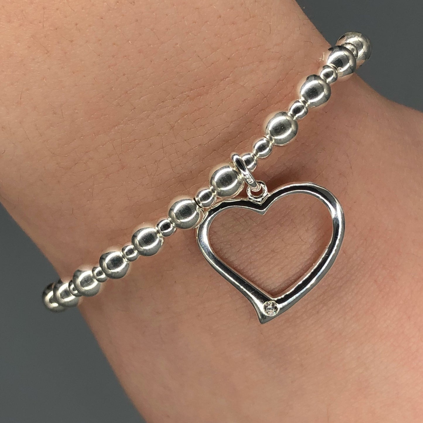Closeup of Large open heart sterling silver stacking charm bracelet by My Silver Wish