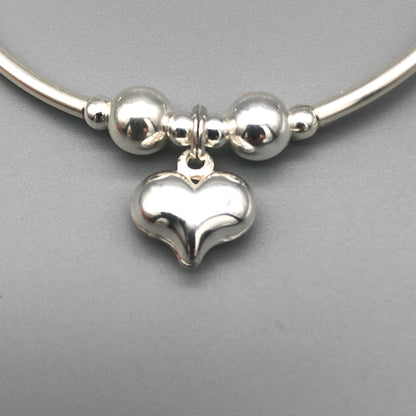 Closeup of Puff heart charm sterling silver hand-made girl's stacking bracelet by My Silver Wish