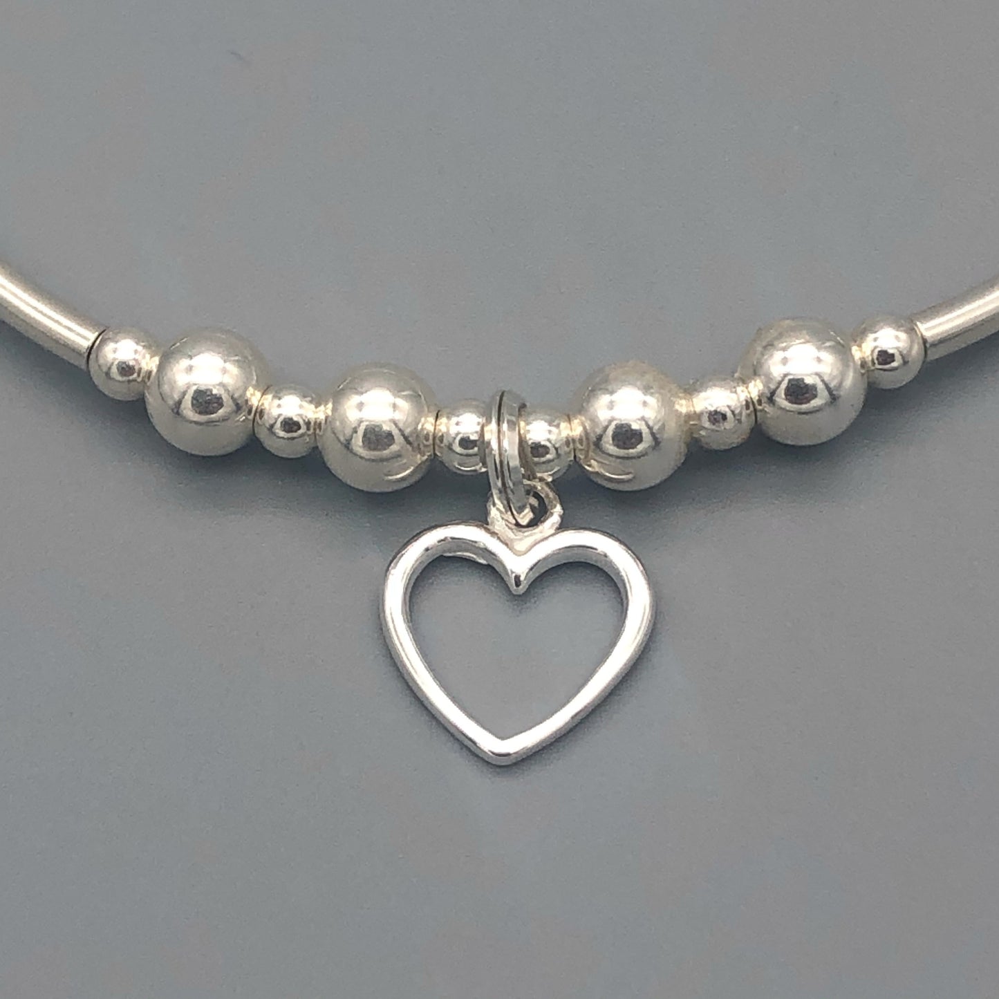 Closeup of Small open heart sterling silver stacking charm bracelet by My Silver Wish