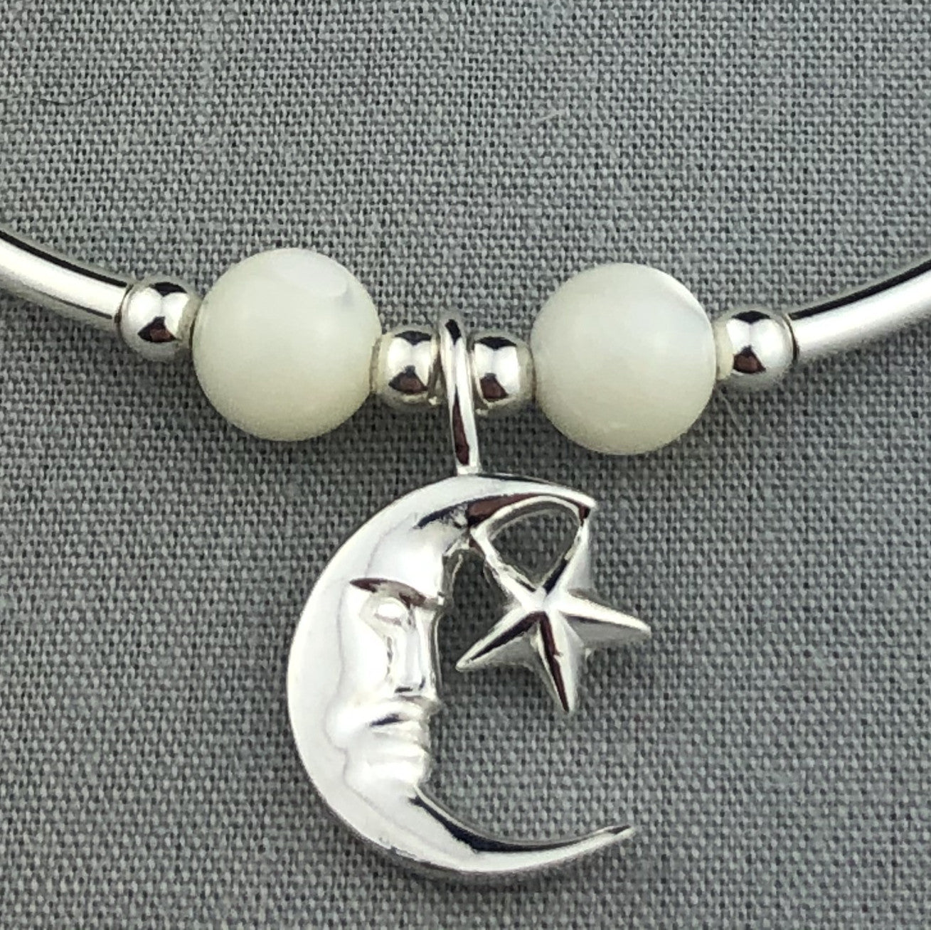 Closeup of Moon & star charm & moonstone women's sterling silver stacking bracelet by My Silver Wish