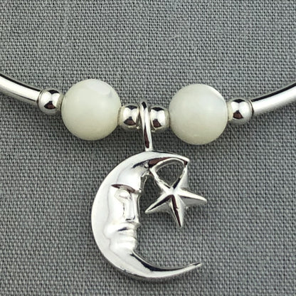 Closeup of Moon & star charm & moonstone women's sterling silver stacking bracelet by My Silver Wish