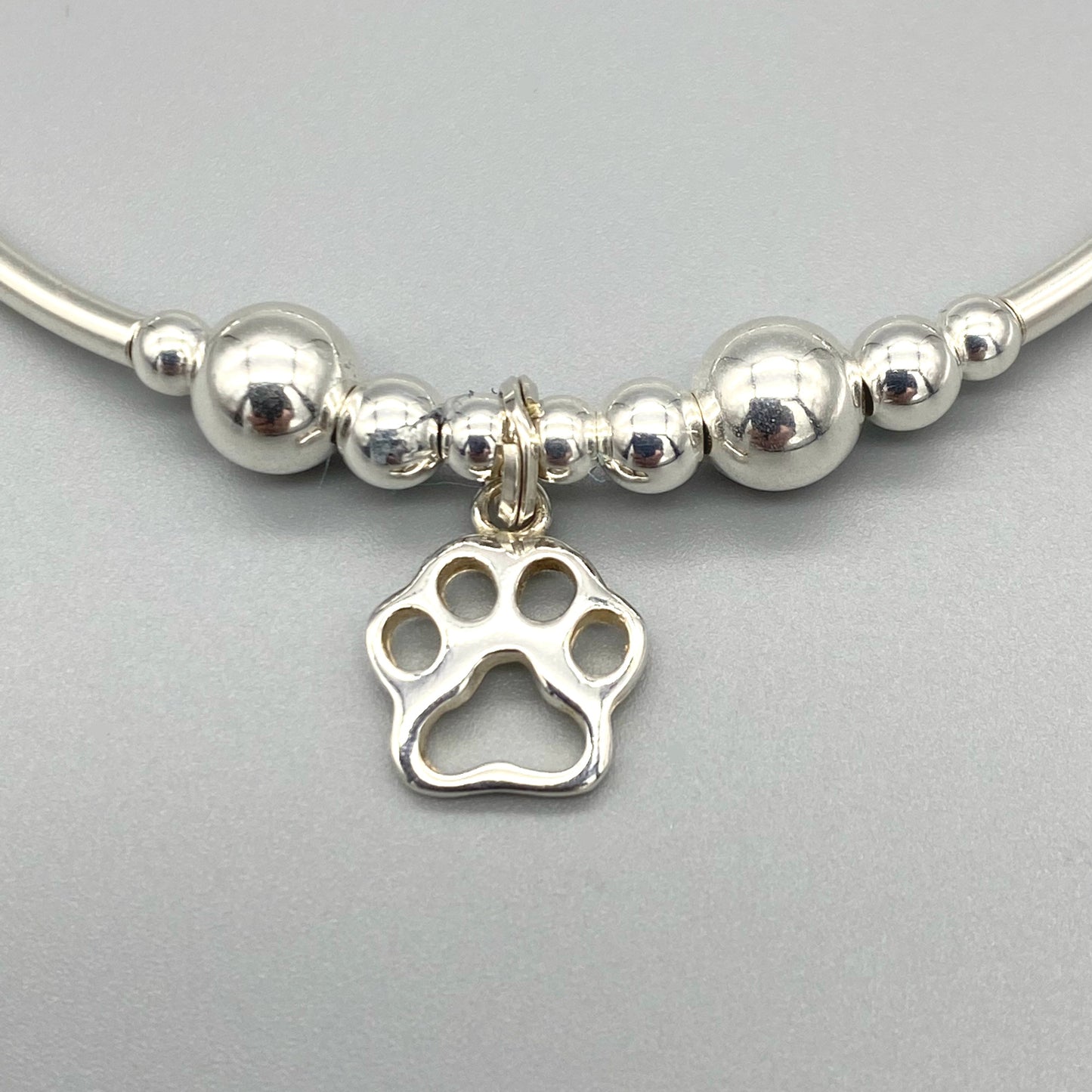 Closeup of Dog Paw Charm Sterling Silver Stacking Bracelet for her by My Silver Wish