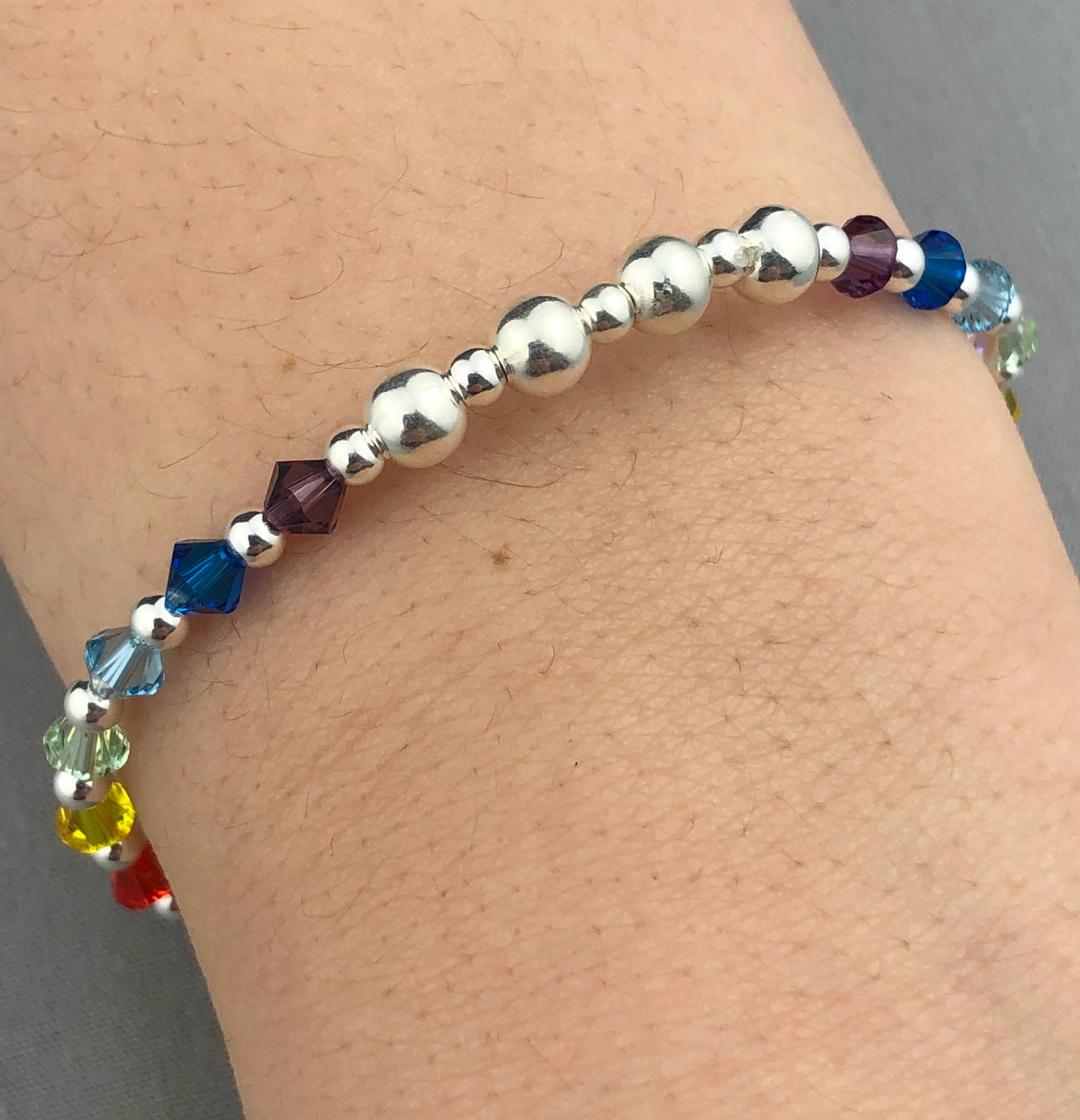 Closeup of "Hope" Rainbow Crystal Sterling Silver Women's Stacking Charm Bracelet by My Silver Wish