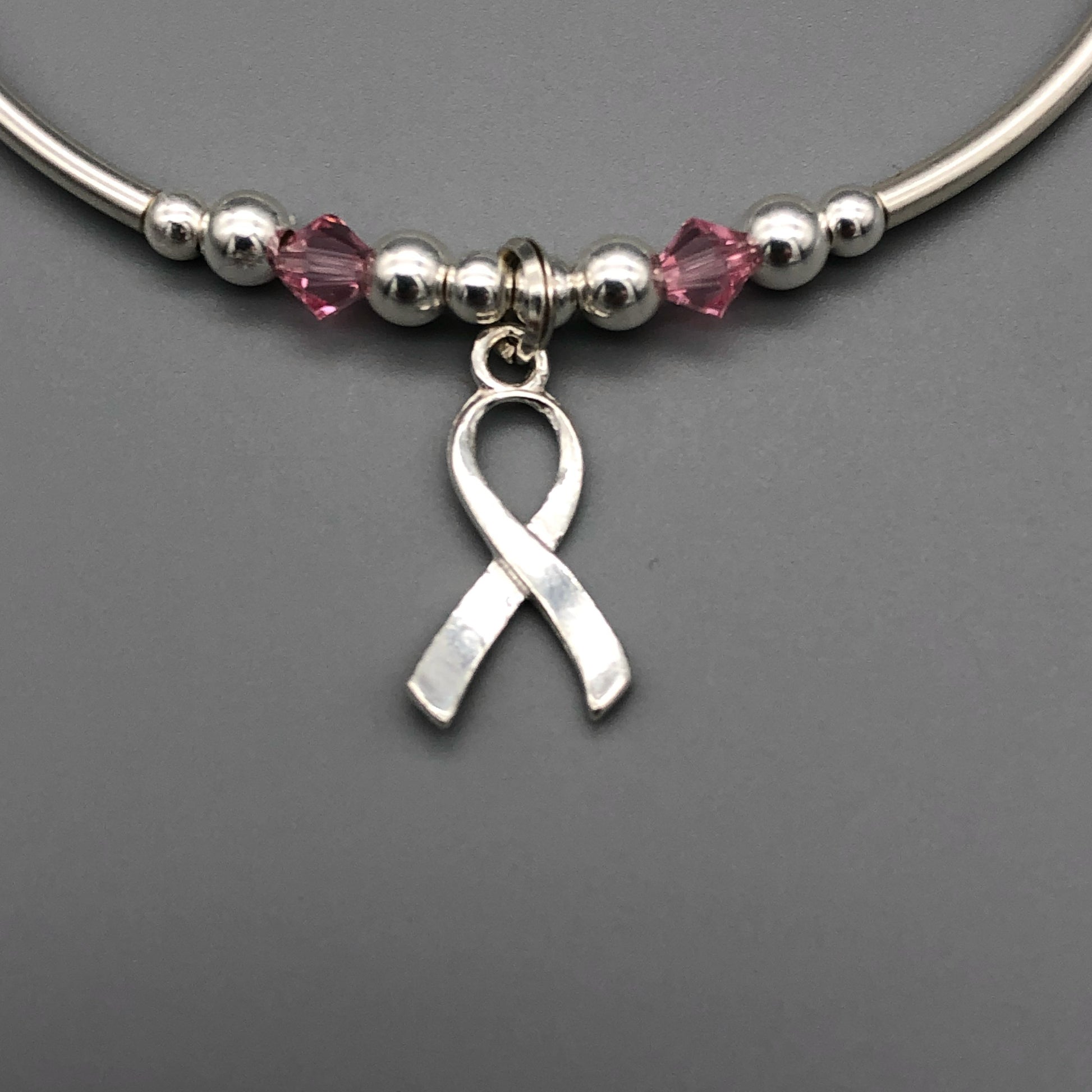 Closeup of Breast Cancer Awareness Ribbon charm sterling silver women's stacking bracelet by My Silver Wish