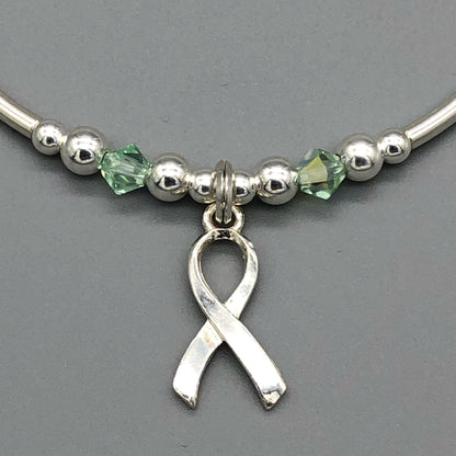 Closeup of Mental Health Awareness ribbon charm sterling silver hand-made women's stacking bracelet by My Silver Wish
