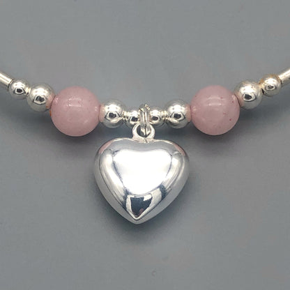 Closeup of Rose quartz solid heart charm sterling silver hand-made women's stacking bracelet by My Silver Wish