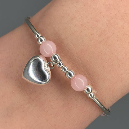 Closeup of Rose quartz solid heart charm sterling silver hand-made women's stacking bracelet by My Silver Wish