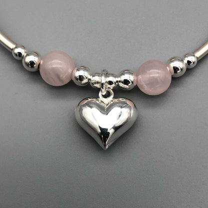 Closeup of Rose quartz puff heart charm sterling silver women's stacking bracelet by My Silver Wish