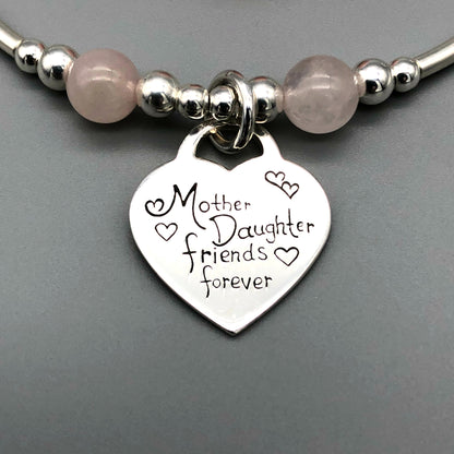Closeup of "Mother Daughter Friends Forever" heart charm rose quartz & sterling silver stacking bracelet by My Silver Wish