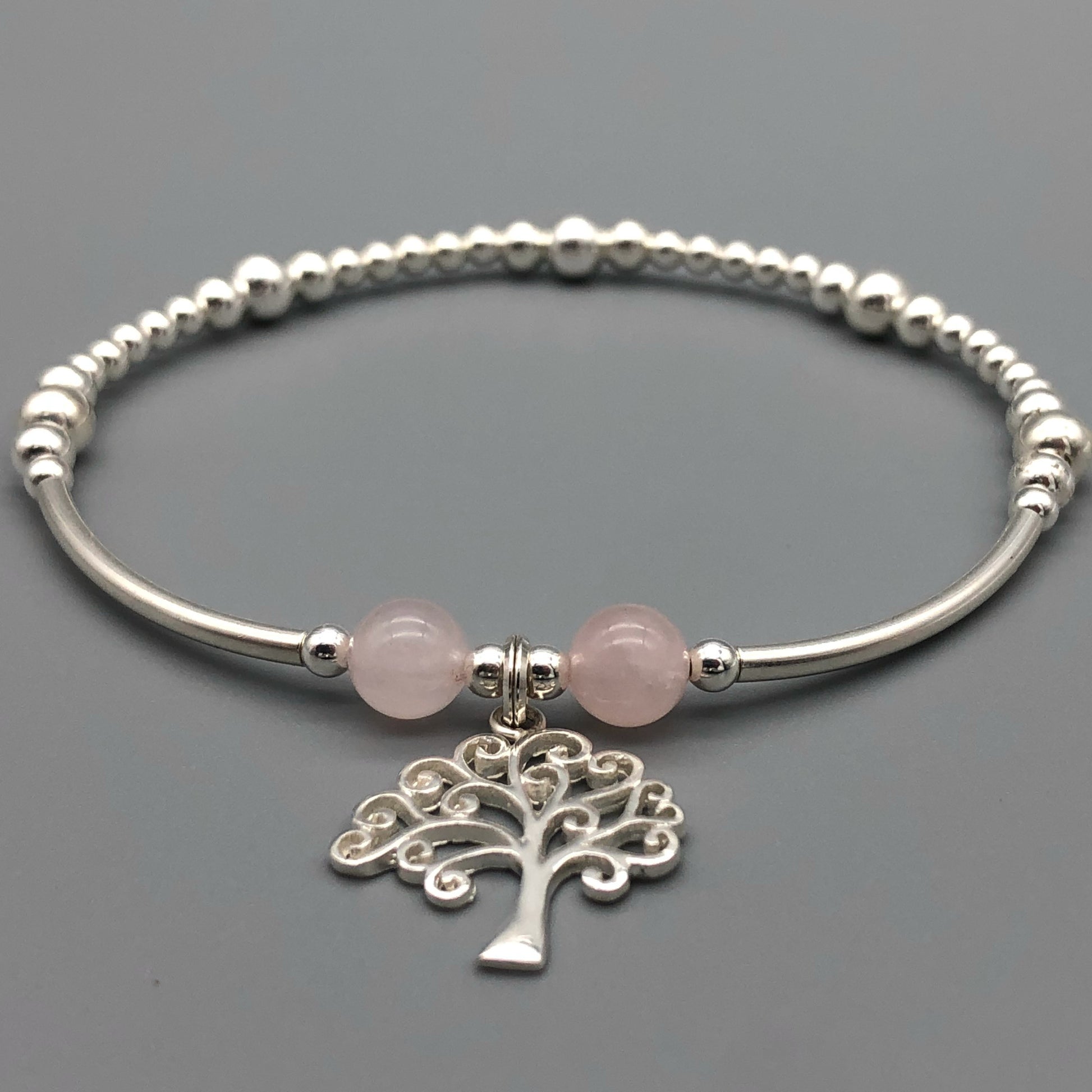 Closeup of Tree of Life charm rose quartz & silver women's stacking charm bracelet by My Silver Wish