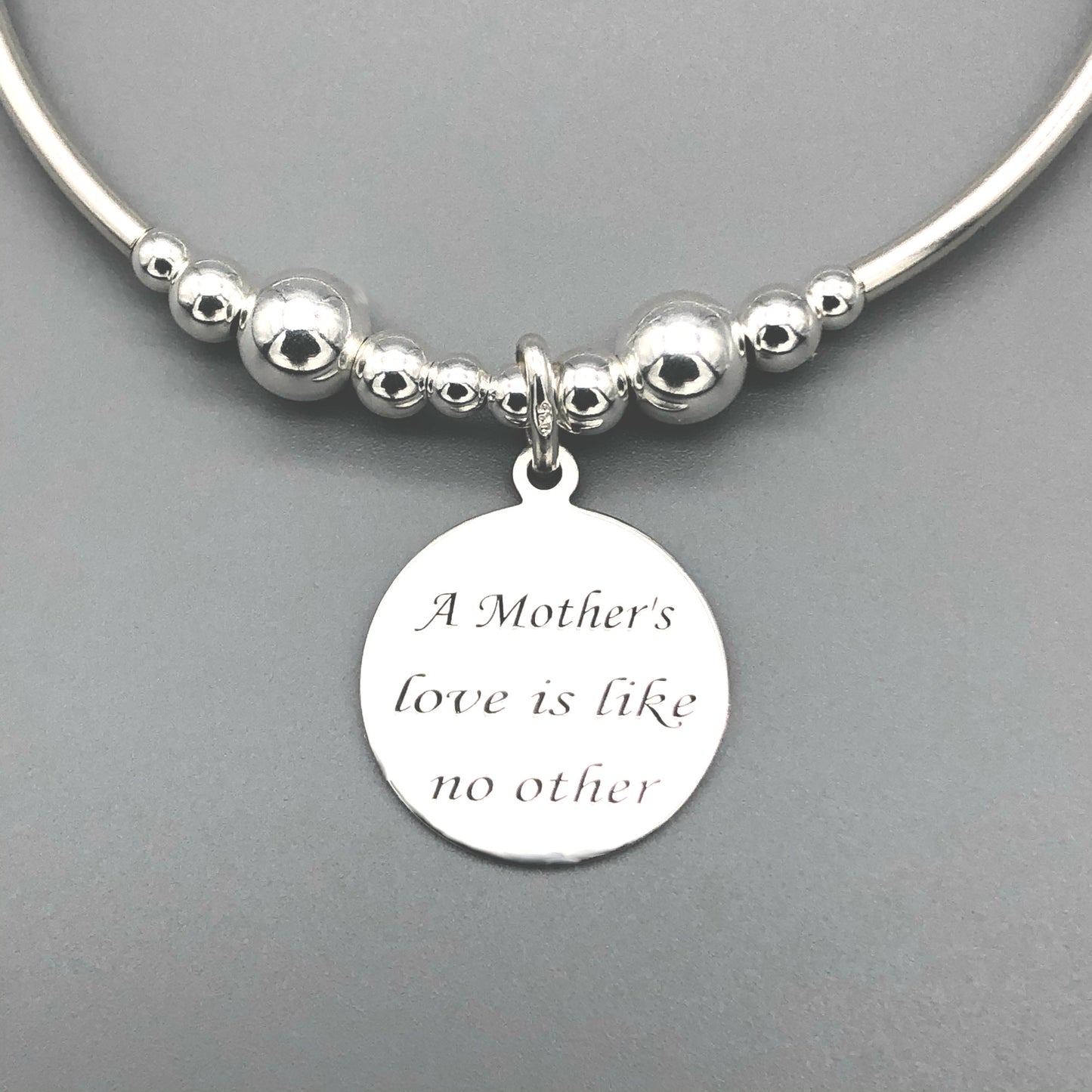 Closeup of "Mother's love is like no other" sterling silver women's charm bracelet by My Silver Wish